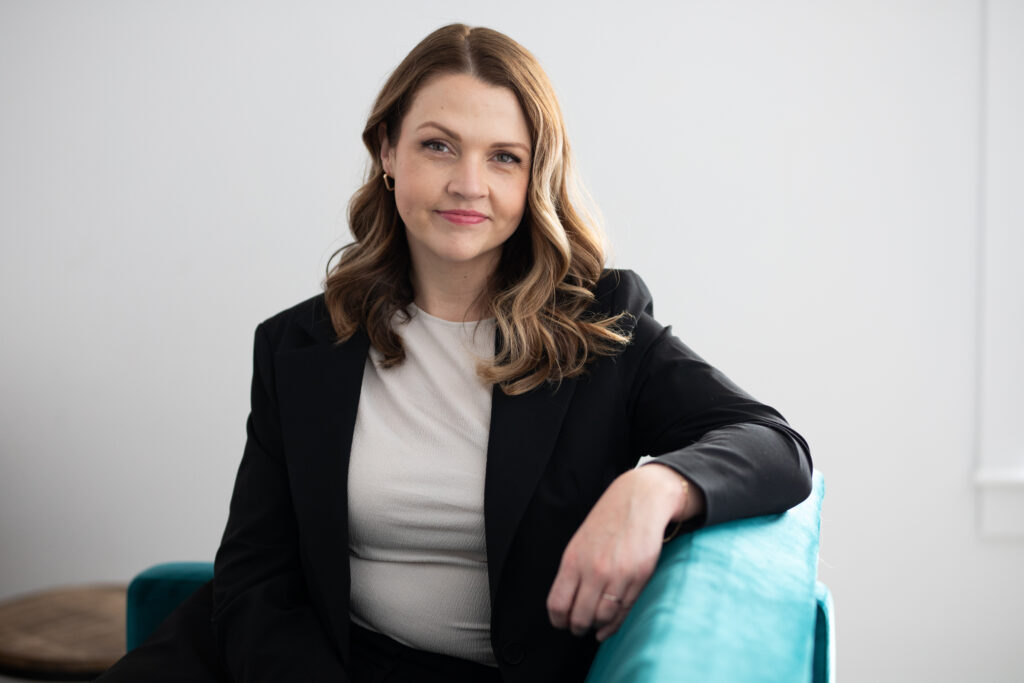 Headshot of a real estate agent in a black blazer 